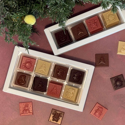 Flèche Healthy Treats vegan sugar-free Christmas chocolates in four flavors with festive holiday designs.