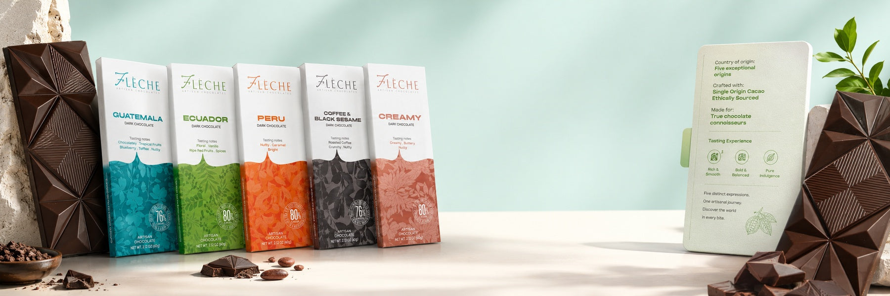 Assorted Fleche chocolate bars on a white surface with a light blue background