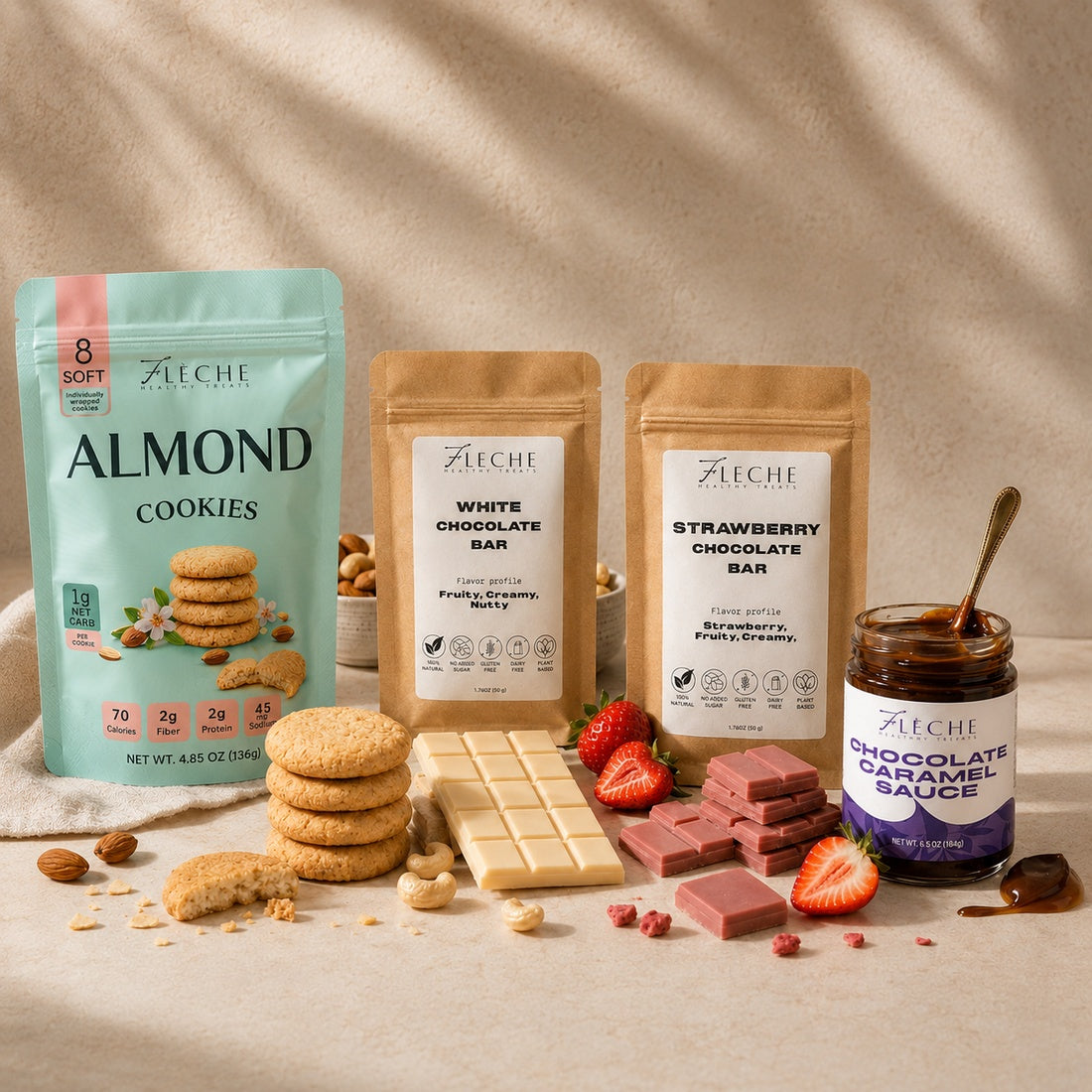 Fleche products including almond cookies, white chocolate bar, strawberry chocolate bar, and chocolate caramel sauce on a neutral background.